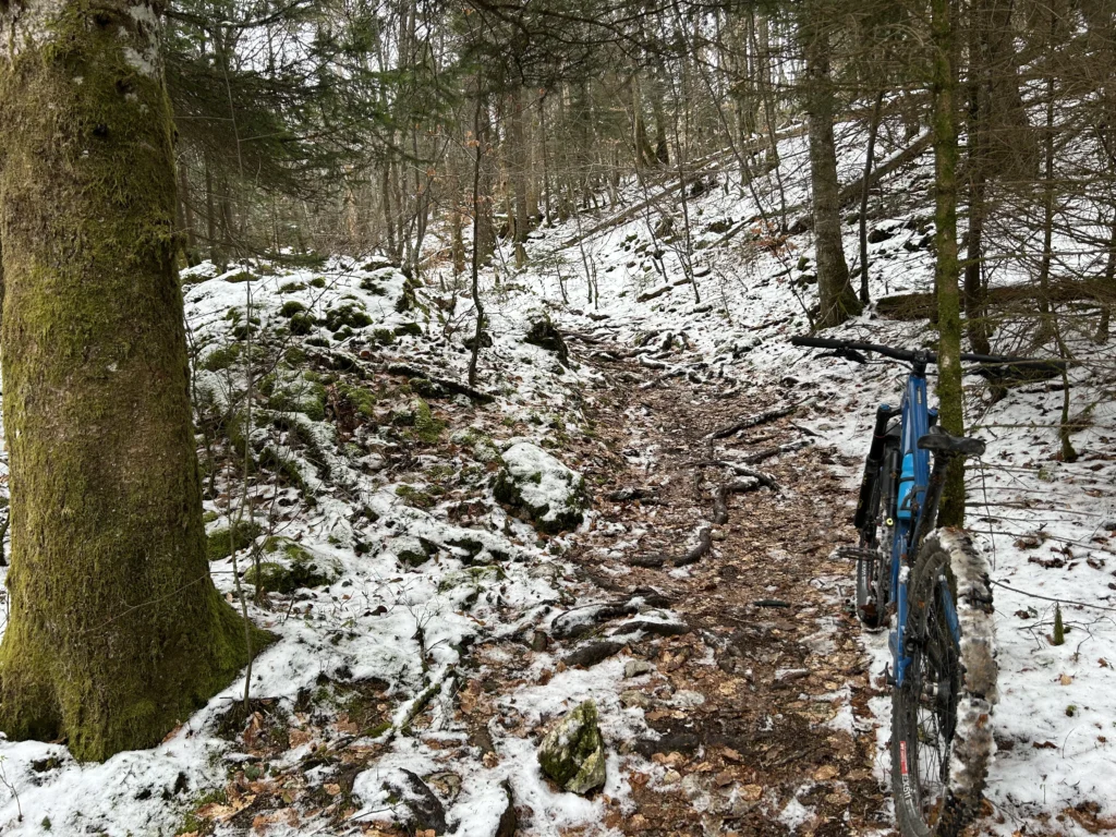 Late spring mountain biking in the snow on Semnoz mountain, Annecy